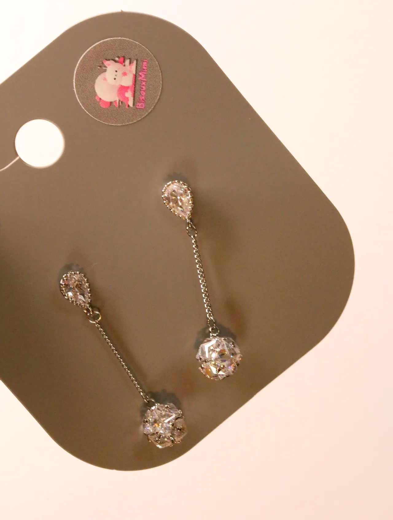 Detalle de las cadenas finas y los colgantes redondos brillantes — pendientes baratos, detalle · Lola y Sol (24AE1215)