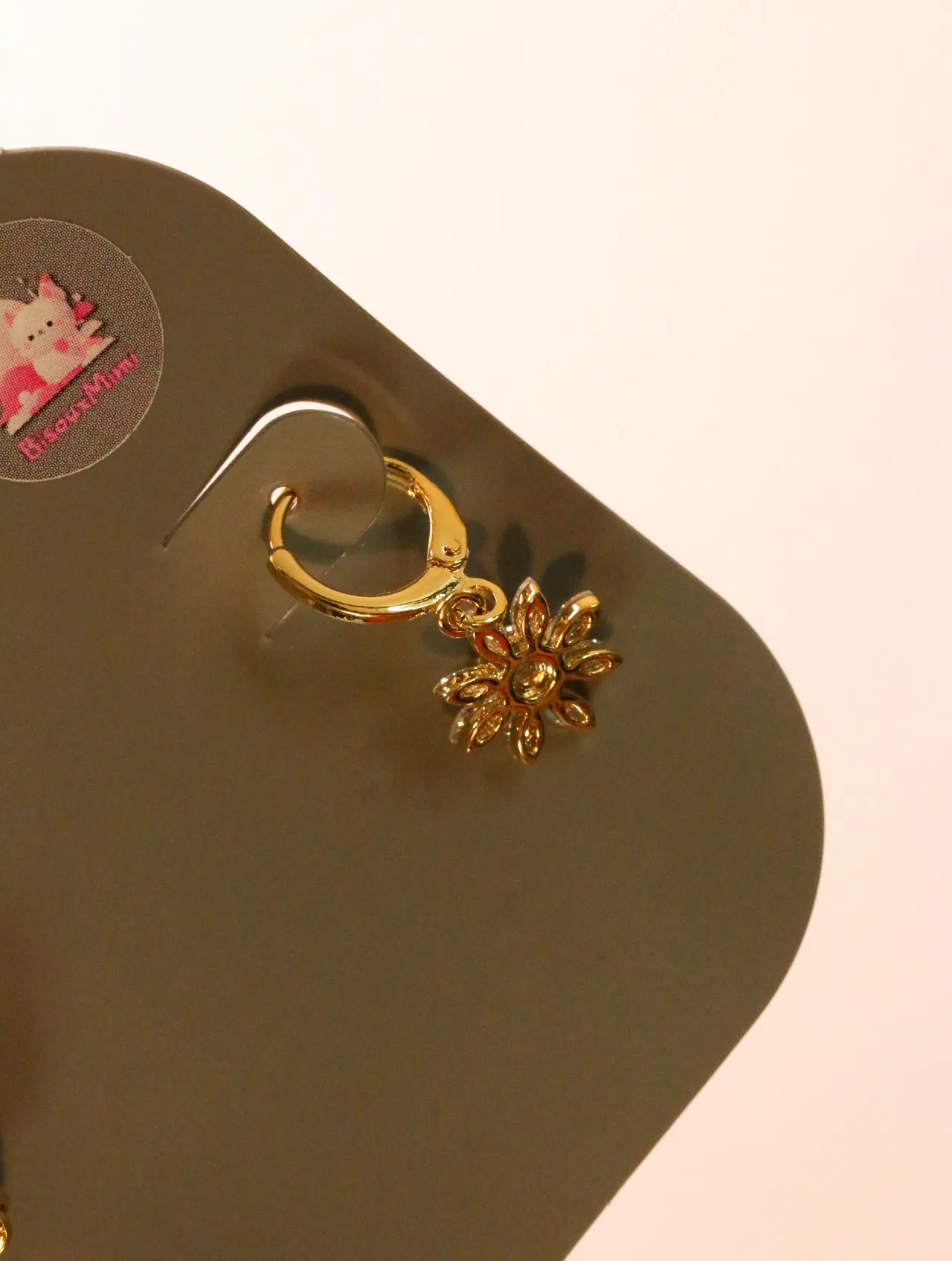 Detalle del aro dorado y la flor colgante — pendientes baratos, detalle · Lola y Sol (24AE1240)