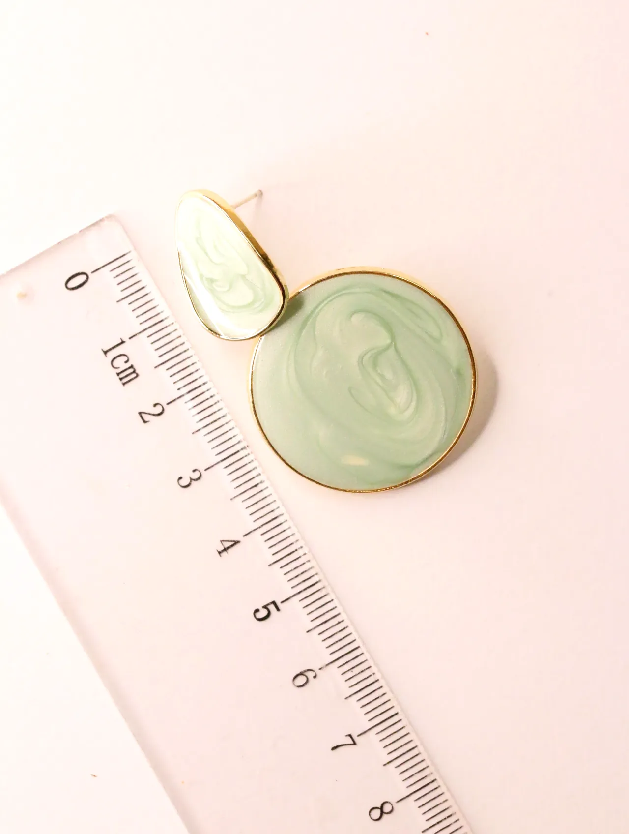 Pendiente colgante verde menta con efecto mármol junto a una regla de medición — pendientes para mujer, vista principal · Lola y Sol (EAR-075)