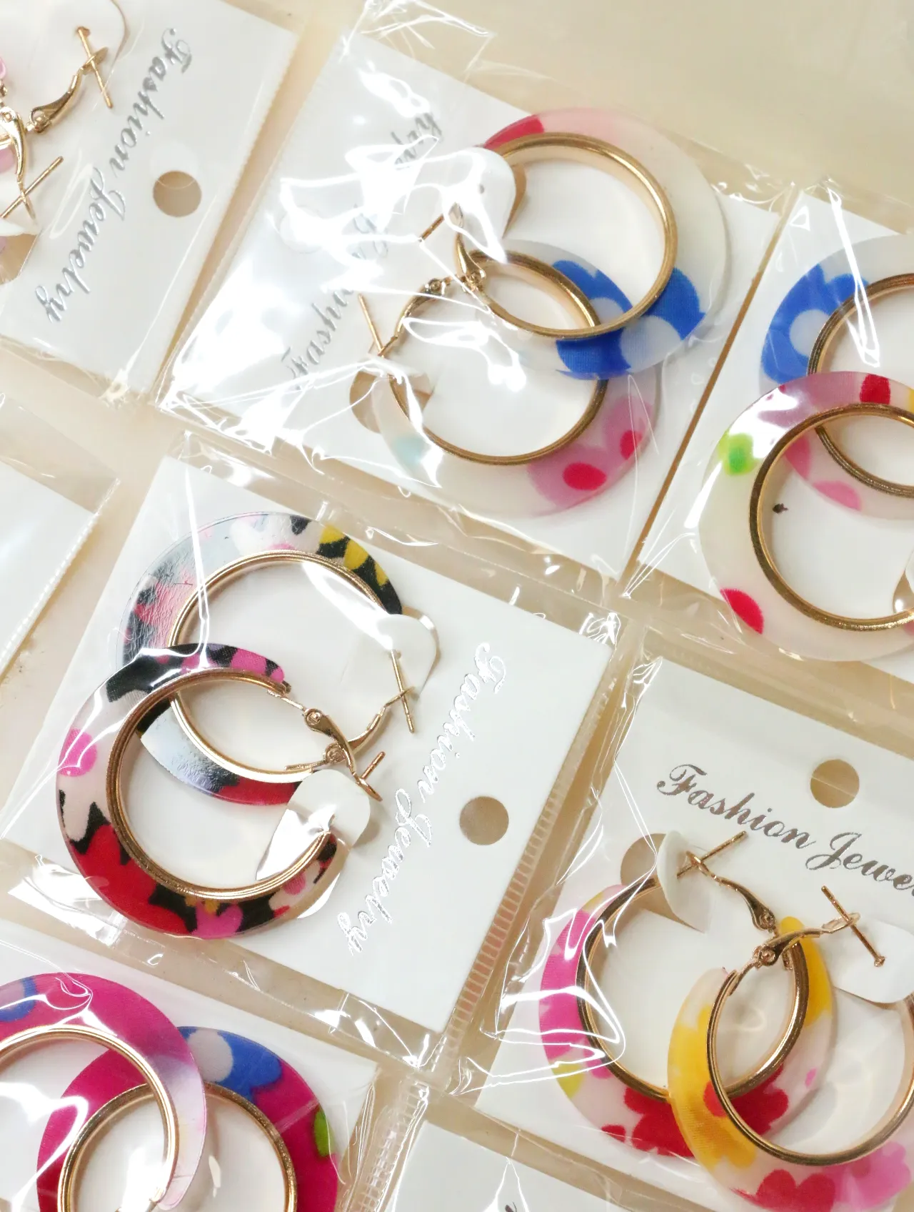 Pendientes de aro coloridos con estampados florales — lote de bisutería originales, detalle del acabado · Lola y Sol (H0008)