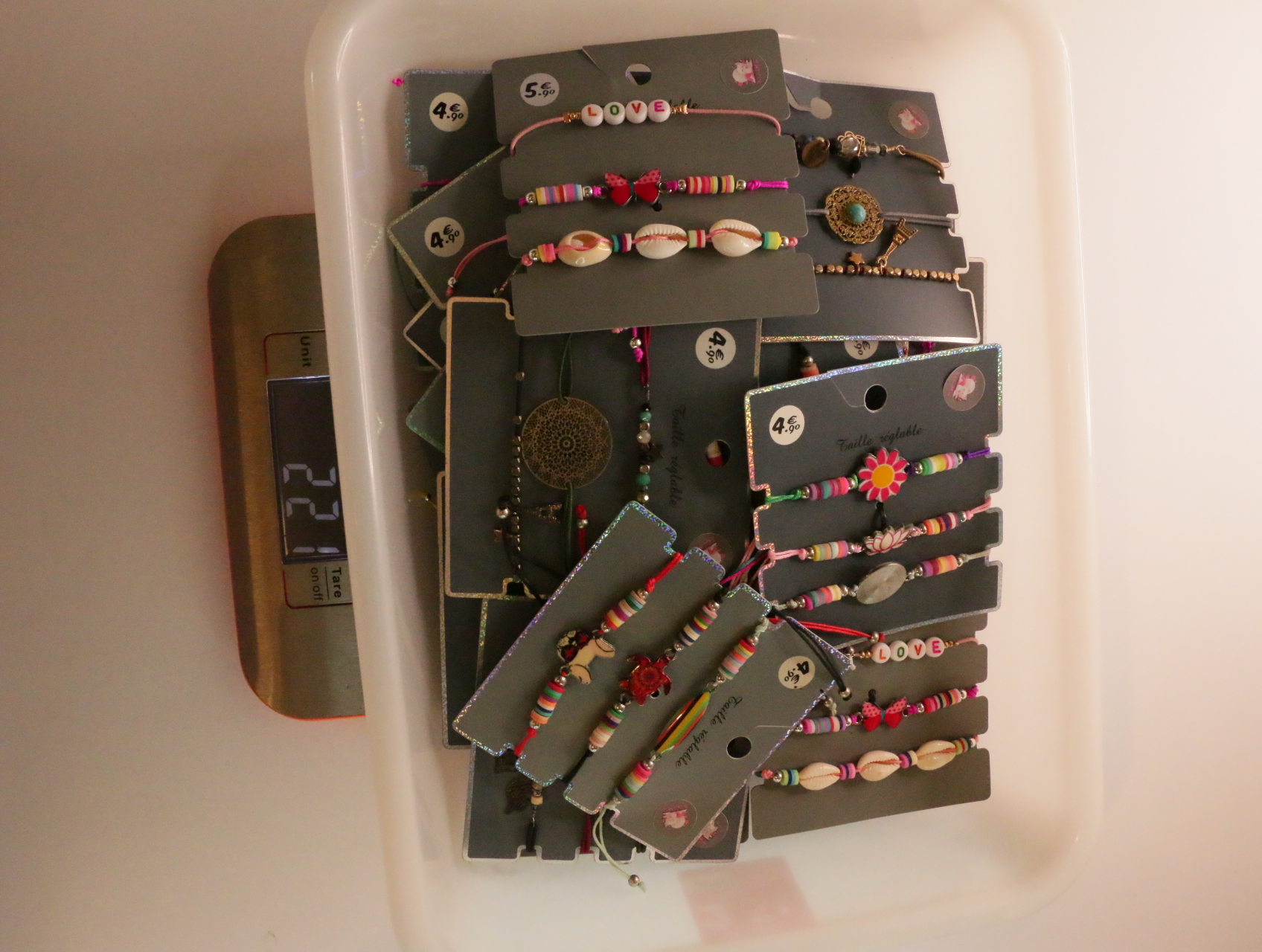 Pulseras multicolor sobre tarjetas expositoras en una bandeja — lote de bisutería baratos, detalle · Lola y Sol (LT054)