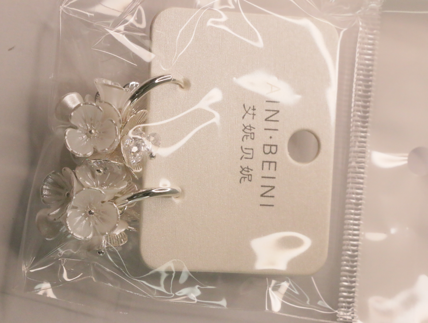 Pendientes colgantes florales sobre su tarjeta — lote de bisutería dorados, primer plano · Lola y Sol (LT063)